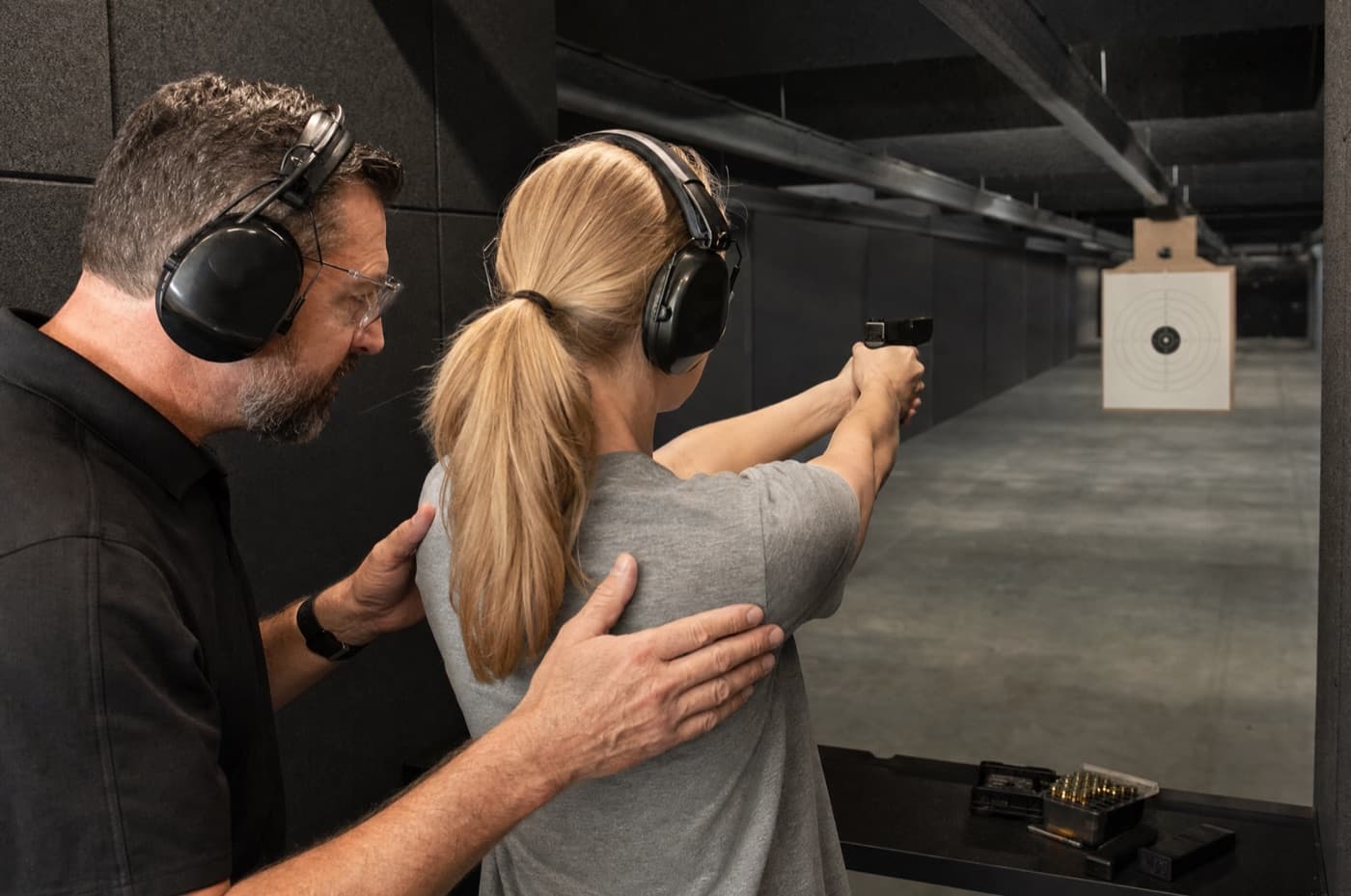 Certified firearm safety instruction at an indoor range.